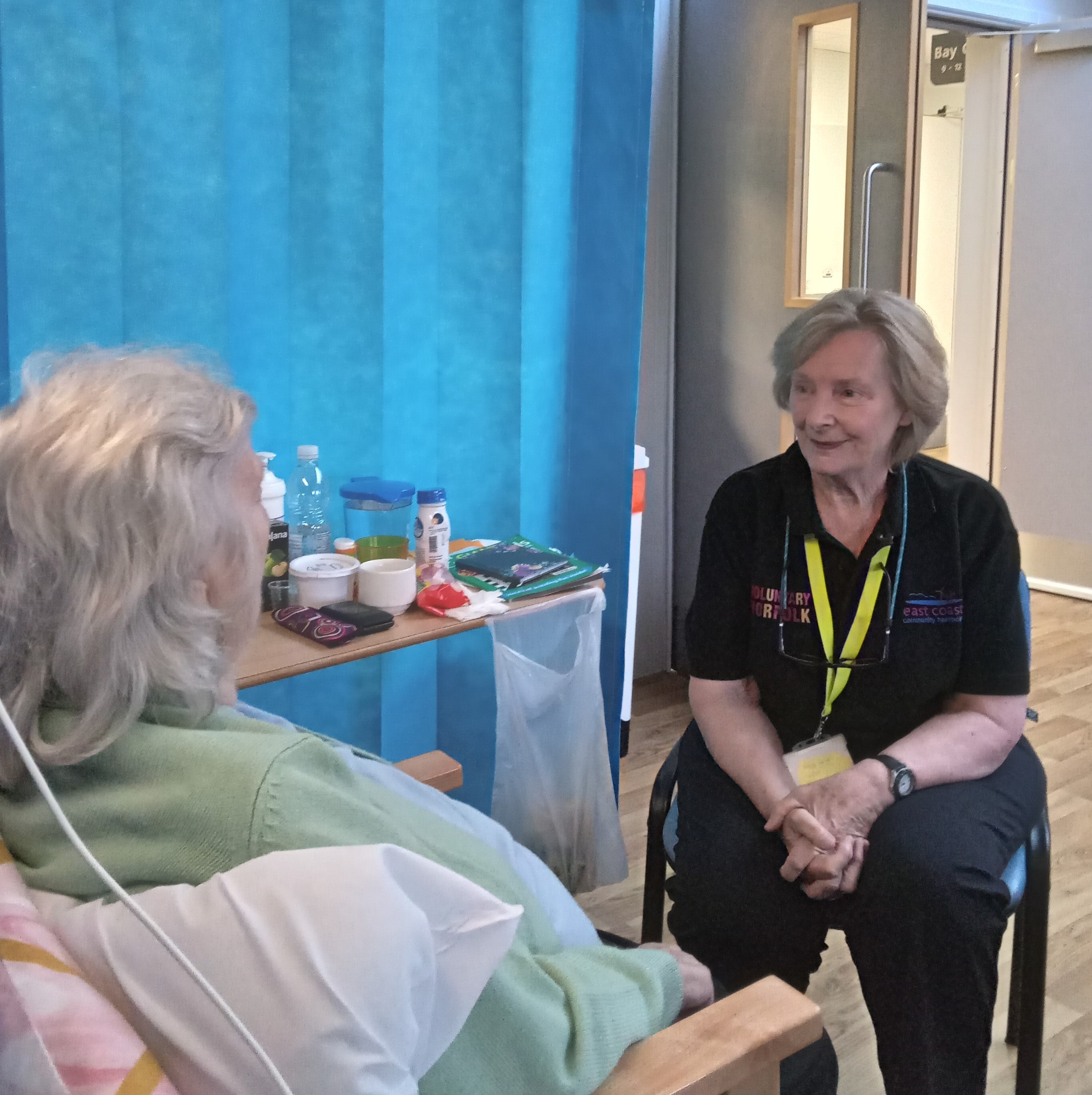 volunteer speaking to patient in hospital